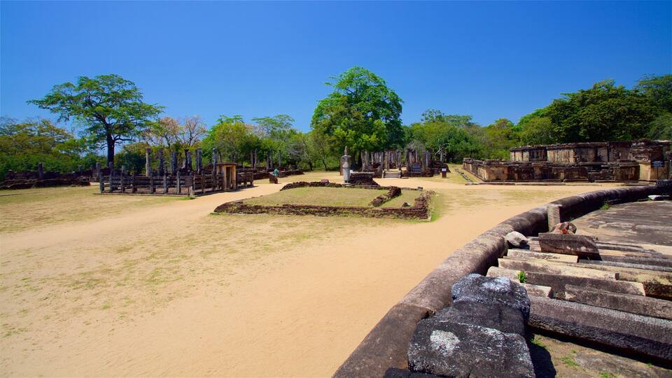 An ancient archaeological site with stone structures and a central stone monument surrounded by a circular stone wall.