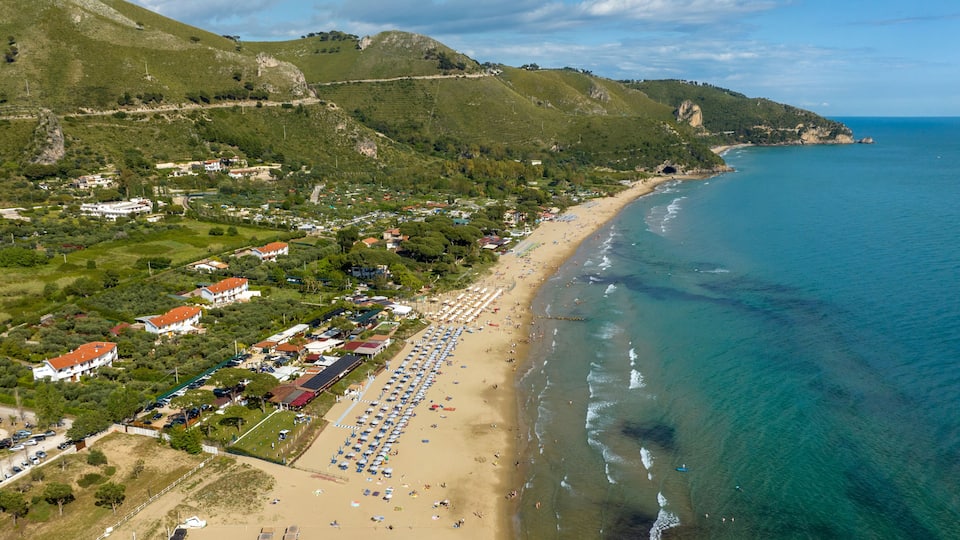 Aerial view of the Levante beach in Sperlonga. It is a tourist destination on the coast in the province of Latina, Lazio, Italy. In the background is the Grotto of Tiberius.
