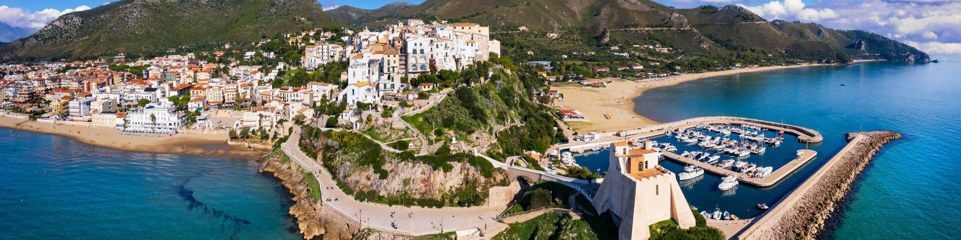 Aerial view of old town Sperlonga and beach, ancient Italian city in province Latina on Tyrrhenian sea, tourists summer vacaton destination.