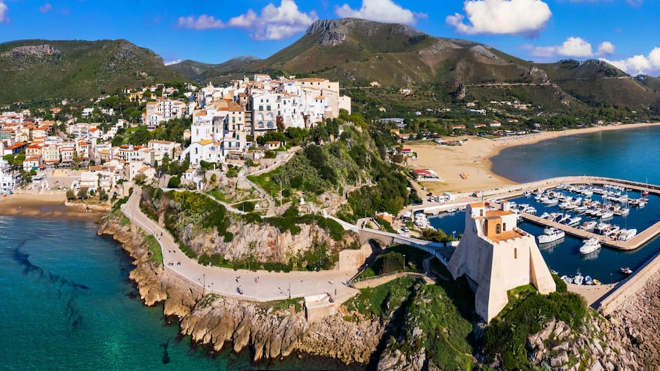 Aerial view of old town Sperlonga and beach, ancient Italian city in province Latina on Tyrrhenian sea, tourists summer vacaton destination.