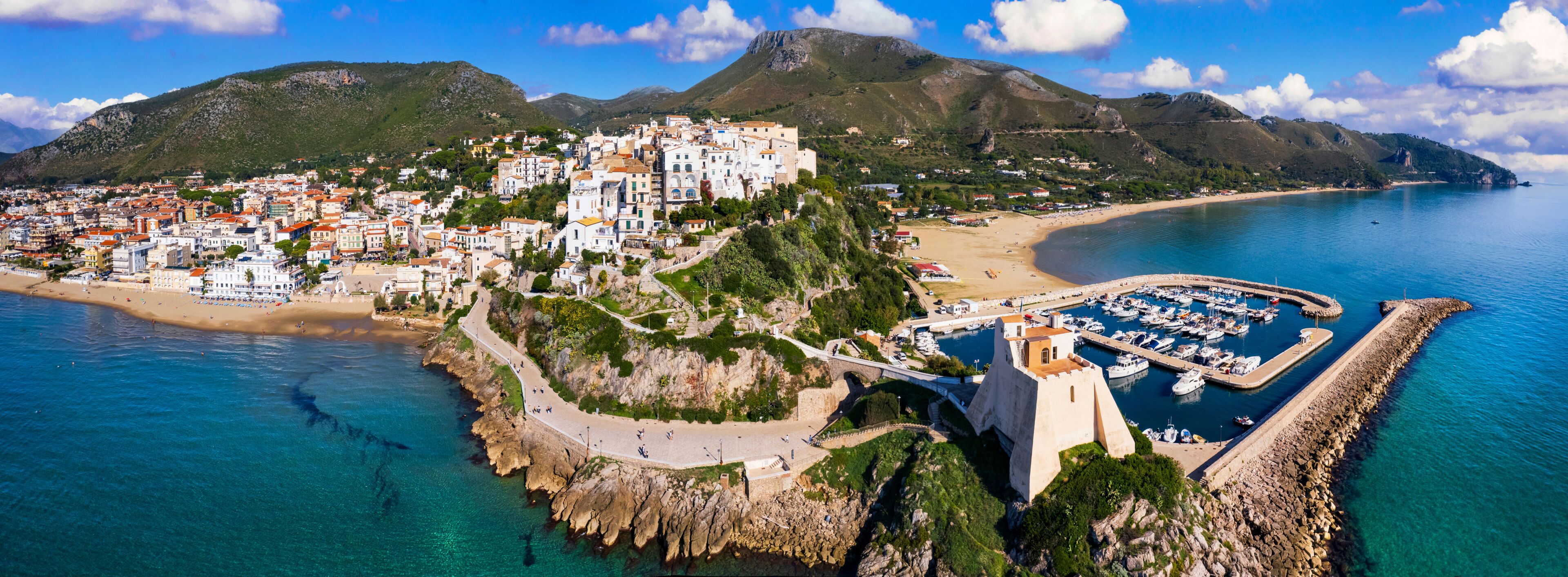 Aerial view of old town Sperlonga and beach, ancient Italian city in province Latina on Tyrrhenian sea, tourists summer vacaton destination.