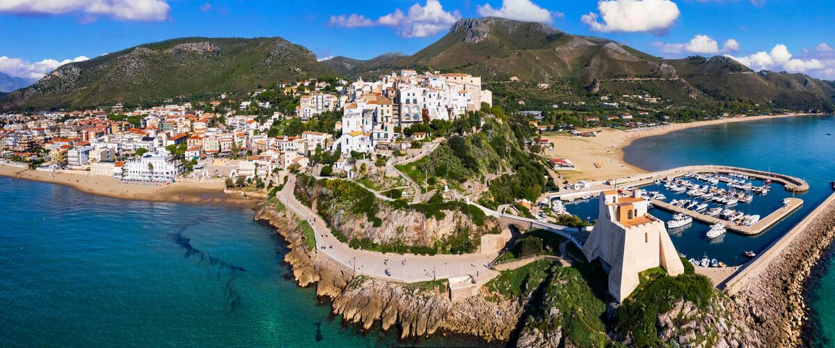 Aerial view of old town Sperlonga and beach, ancient Italian city in province Latina on Tyrrhenian sea, tourists summer vacaton destination.