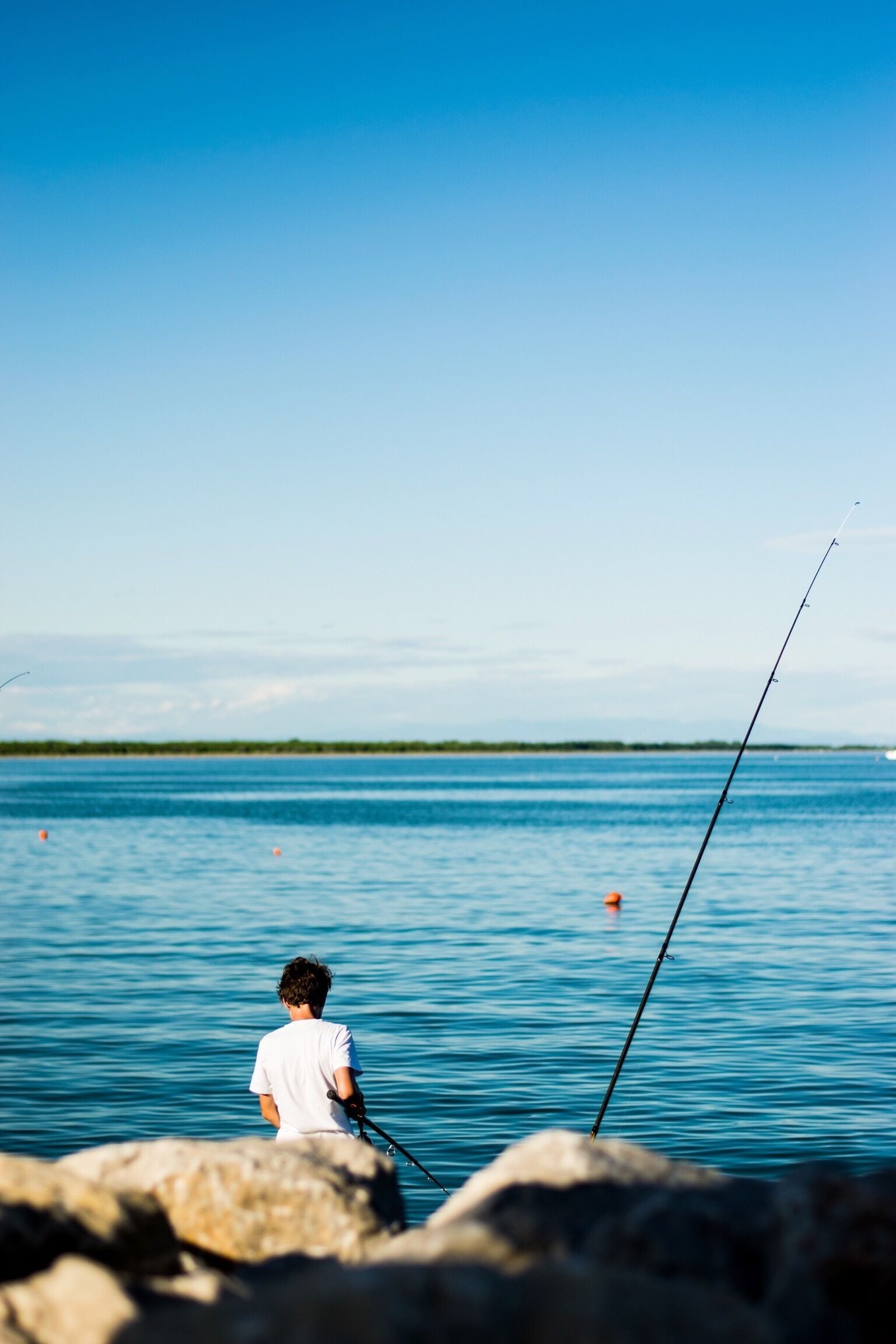 A young italian fisher at a bay in Caorle trying his luck. 