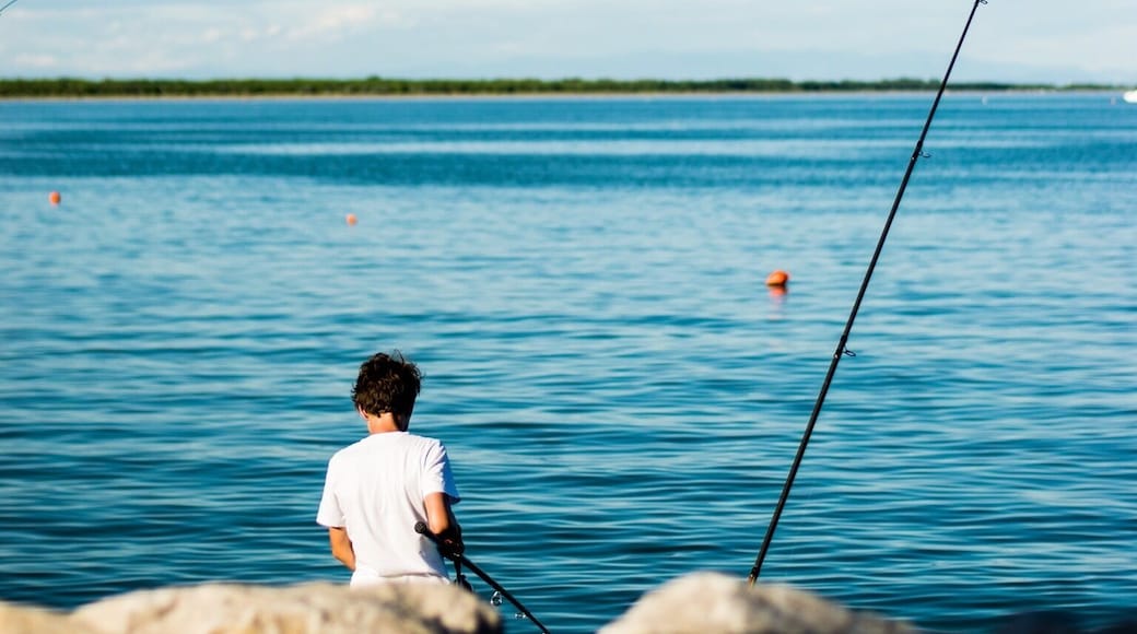 A young italian fisher at a bay in Caorle trying his luck.