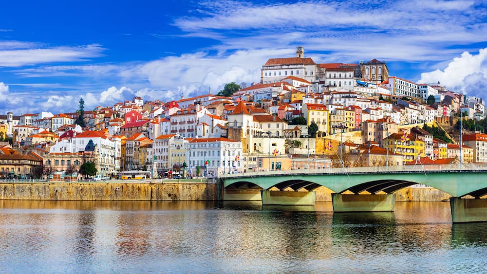 Panoramic view of Coimbra and Mondego river with Santa Clara bridge. Historic city center and University on the hill, UNESCO Heritage, Portugal. 11K High Resolution.