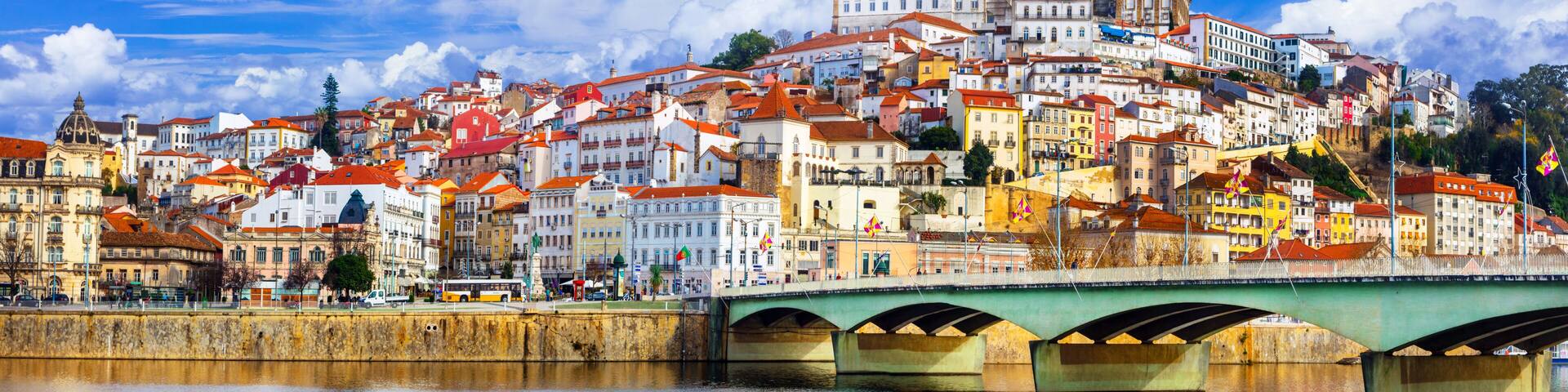 Panoramic view of Coimbra and Mondego river with Santa Clara bridge. Historic city center and University on the hill, UNESCO Heritage, Portugal. 11K High Resolution.