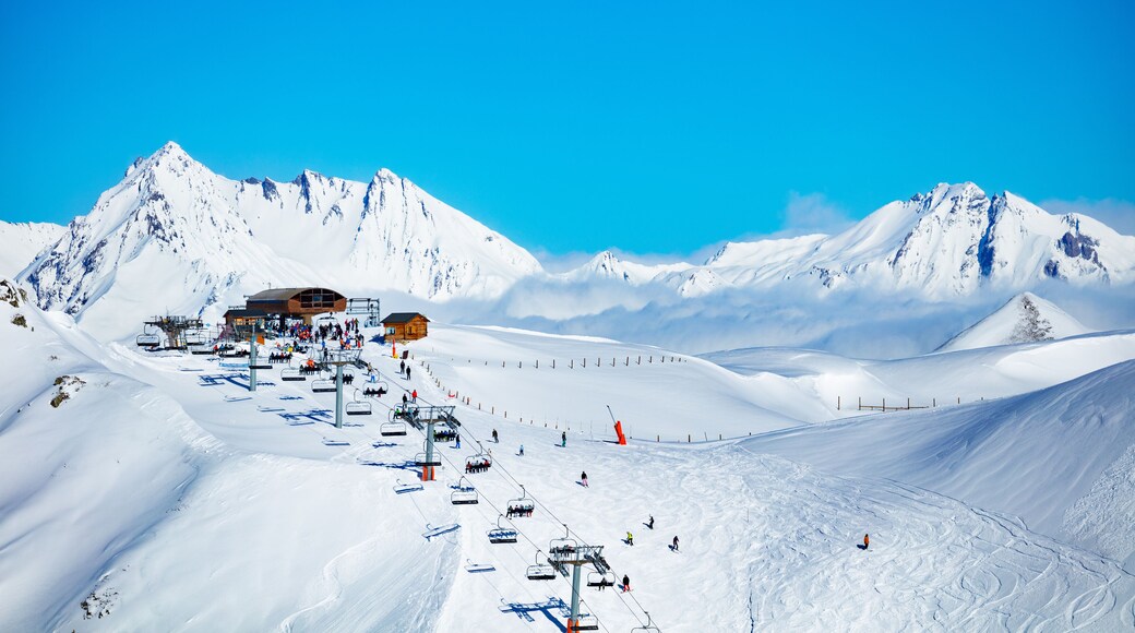 Ski station high in the mountain Les Arcs region of Alps with chairlifts and snow peaks on background