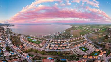 The incredible sunset over the bay of L'Ampolla and Deltebre, Catalonia, Spain. Drone aerial panorama