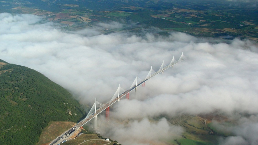 Millau showing a bridge and mist or fog