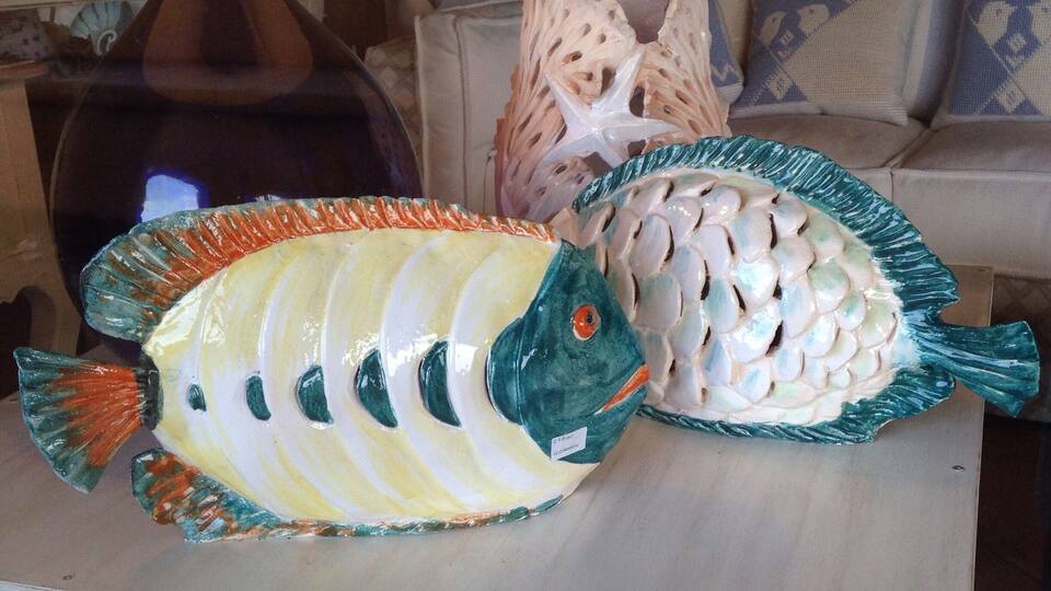 Two ceramic fish on display.