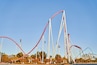 A roller coaster with multiple tracks and a clear blue sky.