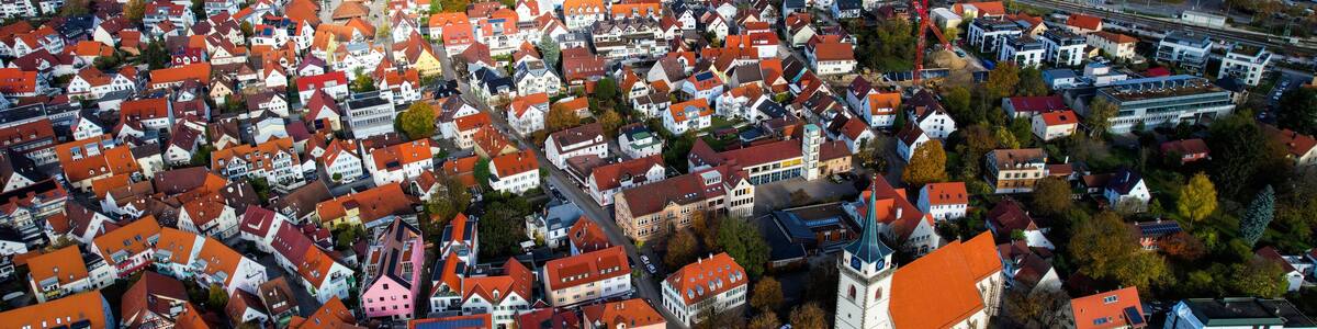 Aerial view of the old town of the city Metzingen
in Germany on a sunny afternoon in autumn