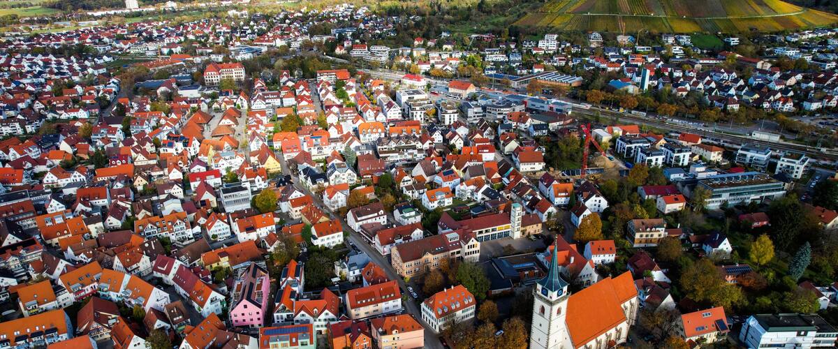 Aerial view of the old town of the city Metzingen
in Germany on a sunny afternoon in autumn