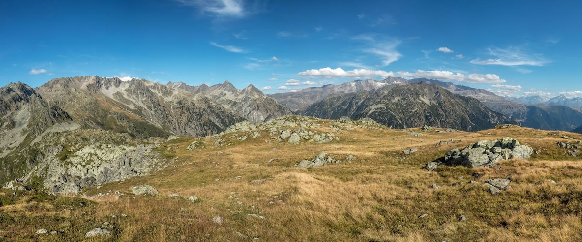 A mountainous landscape with rocky terrain and sparse vegetation.