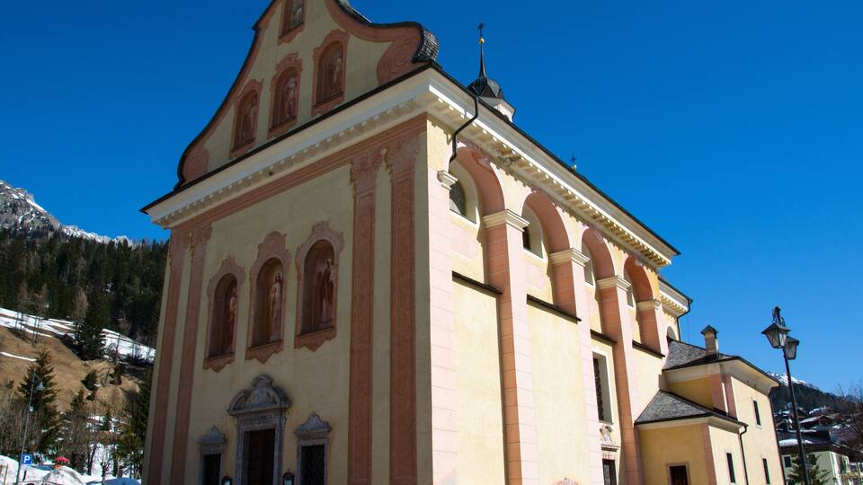 A historic building with arched windows and a bell tower.