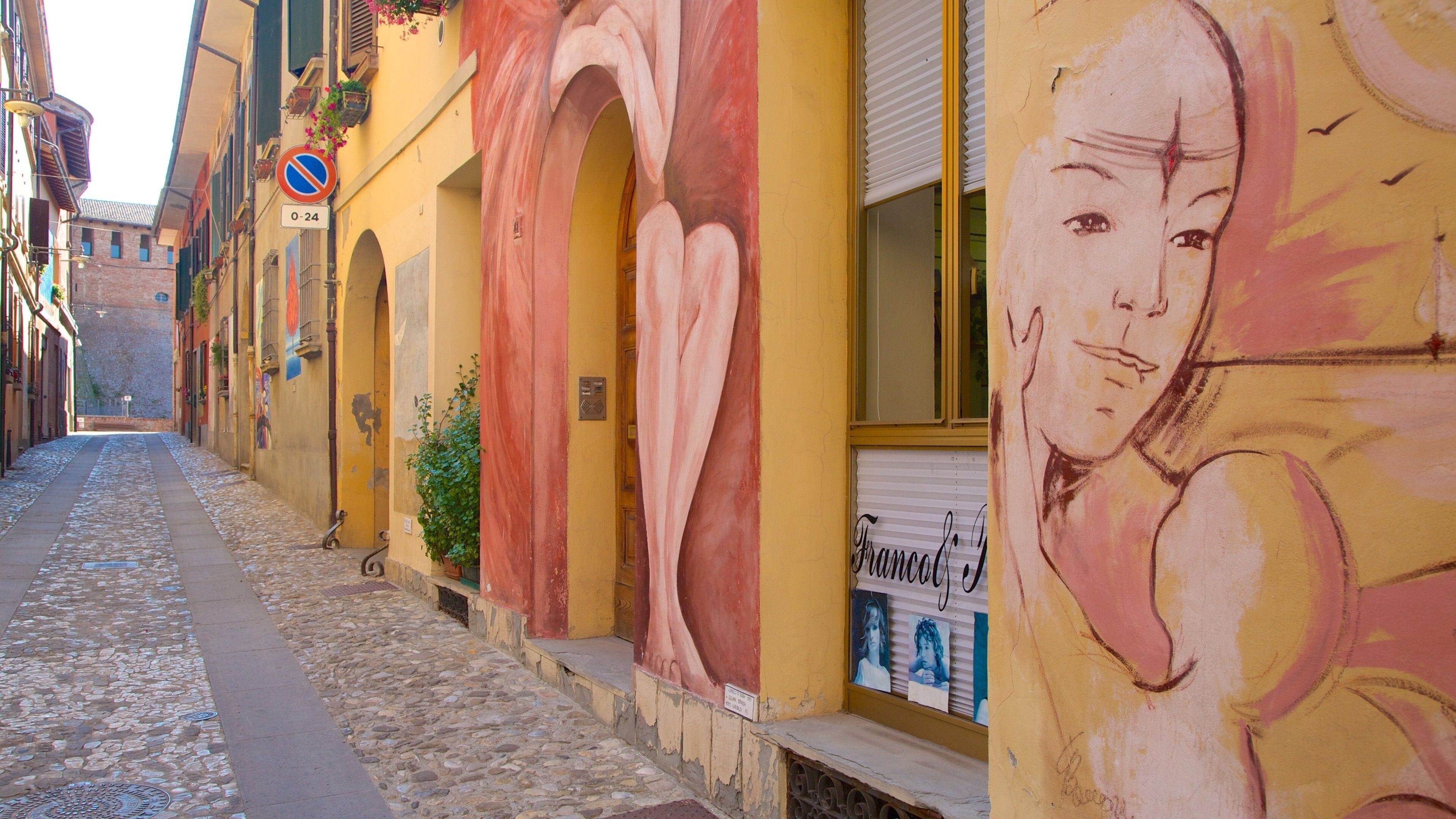 Dozza featuring outdoor art and a small town or village