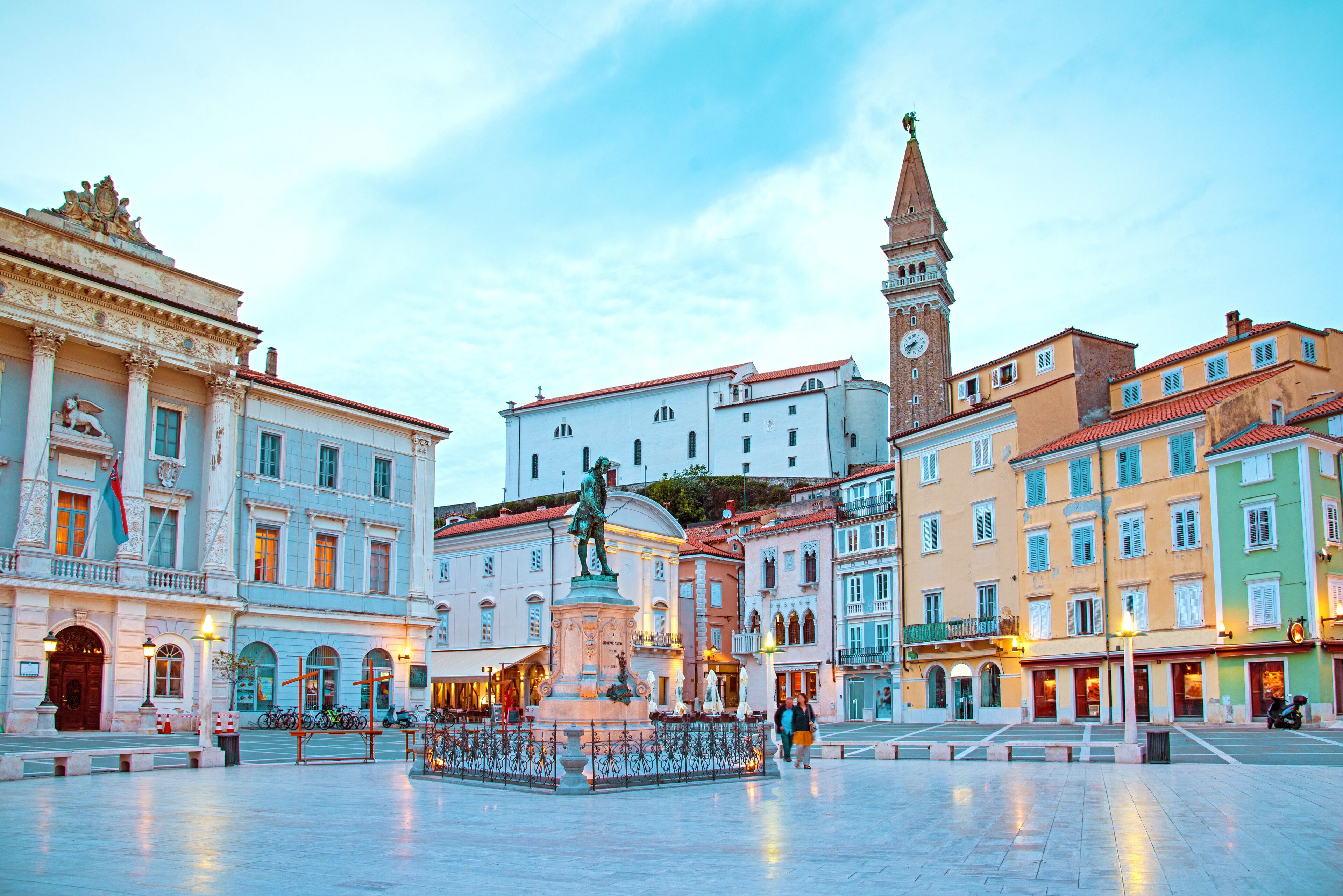 Beautiful street landscape on the central square with a monument and an ancient watch tower in Porec, Croatia's tourist center.