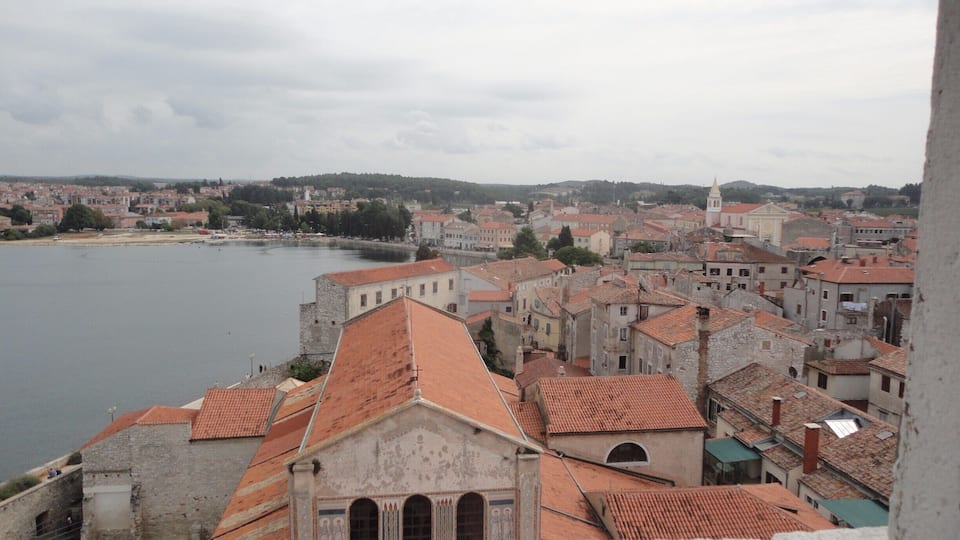 A coastal town with historic buildings and a river.