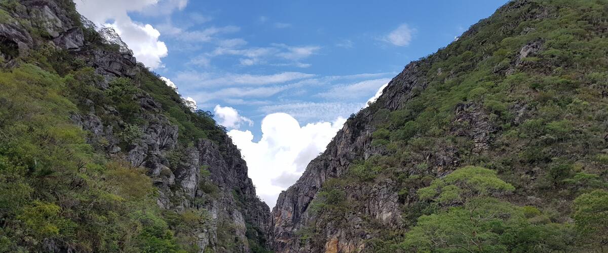 A rocky canyon with hikers.