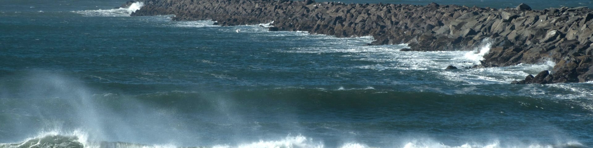 Dramatic storm surf near Westport Jetty with Ocean Shores in the background