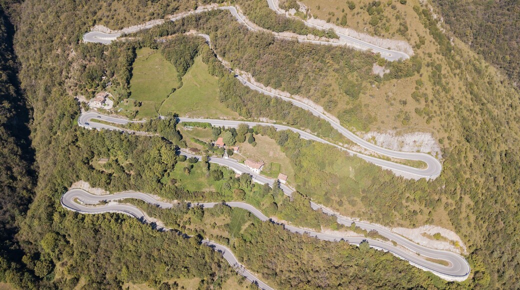 Up and down drone aerial view of the mountain road in Italy that connects the village of Nebro to Selvino. Amazing aerial view of the mountain bends creating beautiful shapes