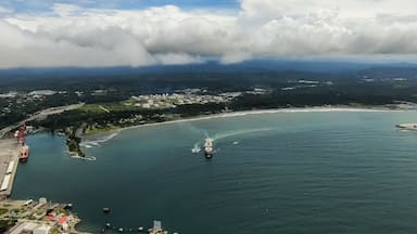 A coastal town with a harbor, boats, and a ship.