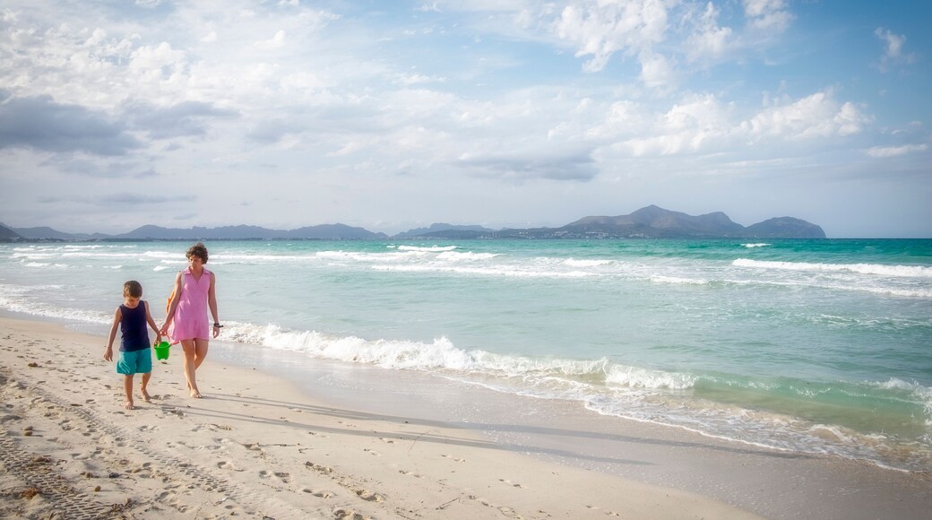 mother and son walk on a white sand beach with turquoise waters, in Playa de Muro, Palma de Mallorca, Balearic Islands, Spain, panoramic, copy space