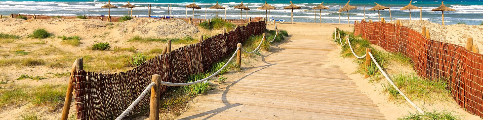 Path sandy beach sea waves white clouds blue sky, Can Picafort, Majorca island, Spain; Shutterstock ID 136391342