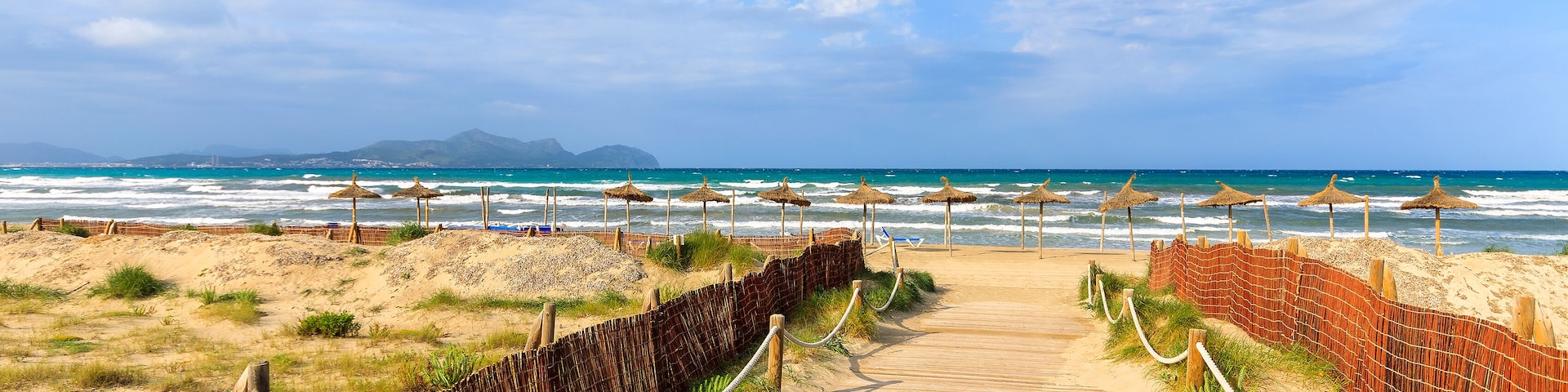 Path sandy beach sea waves white clouds blue sky, Can Picafort, Majorca island, Spain; Shutterstock ID 136391342