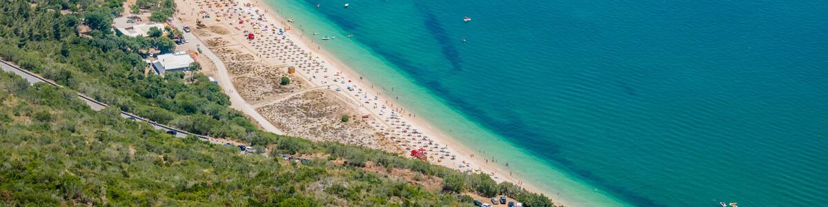Portinho da Arrábida beach in aerial view with extensive sand and rock in the sea, Setúbal PORTUGAL