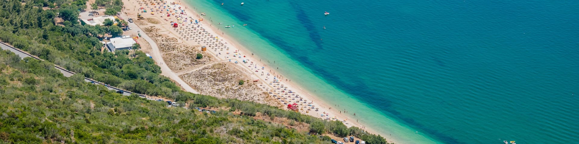 Portinho da Arrábida beach in aerial view with extensive sand and rock in the sea, Setúbal PORTUGAL