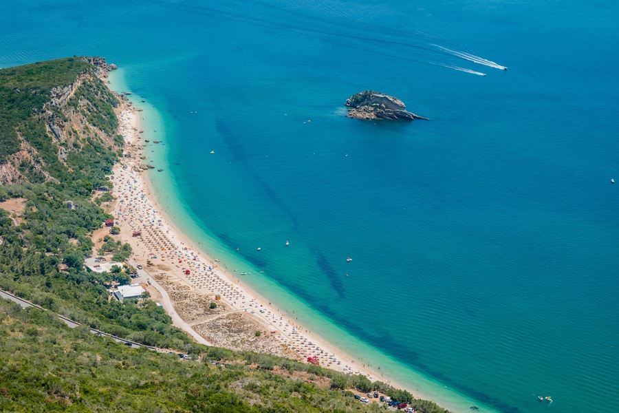 Portinho da Arrábida beach in aerial view with extensive sand and rock in the sea, Setúbal PORTUGAL