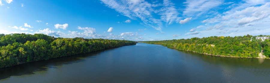 Aerial view of Mississippi river with green trees,  blue sky and white clouds panorama Minnesota  USA