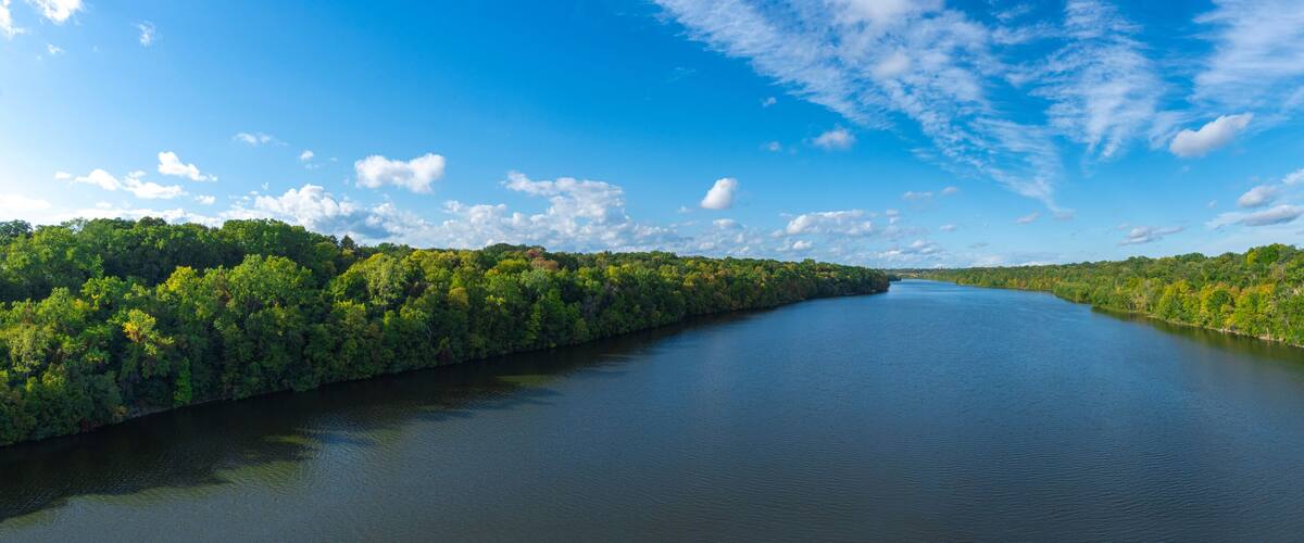 Aerial view of Mississippi river with green trees, blue sky and white clouds panorama Minnesota USA