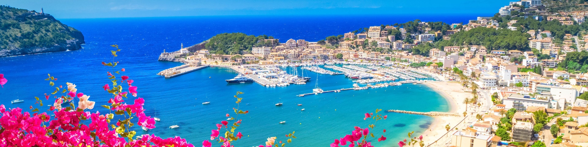 view of Port Soller harbour from above, Mallorca at summer with flowers, Spain, web banner