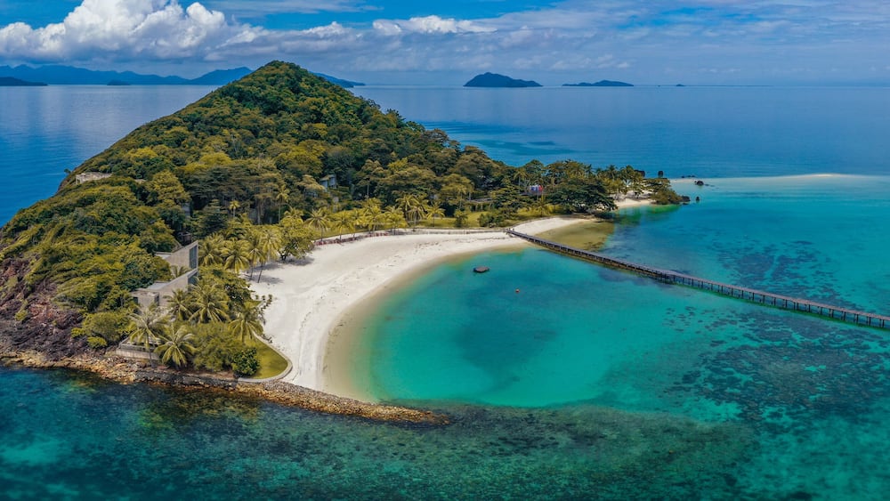 Beautiful tropical island koh Kham, white sand beach with volcanic rocks, near koh Mak, Trat, Thailand