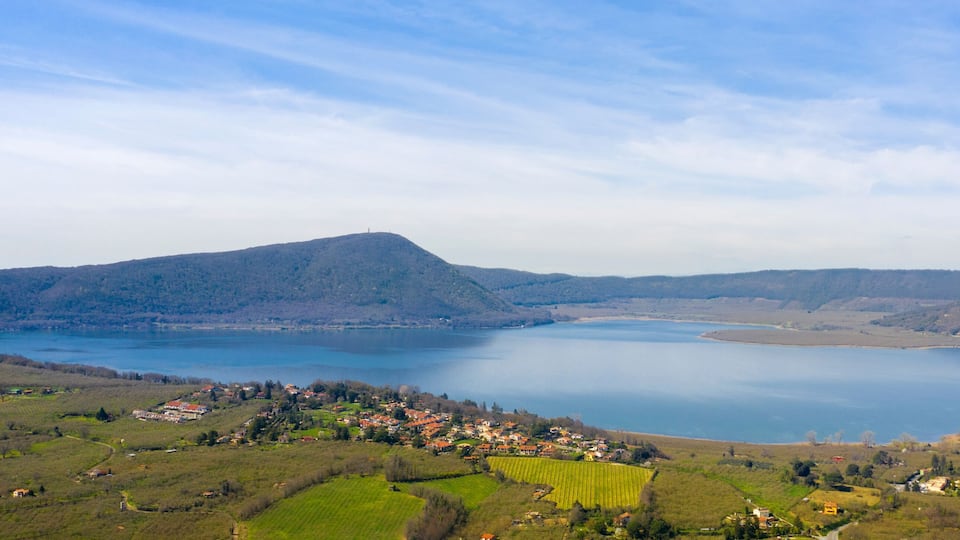 A lake surrounded by hills and a small village.