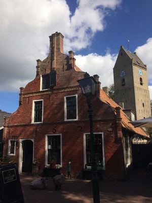 Characteristic Commandeur house on Ameland (Nes). In the background the village tower of Nes, Valerius (Watse) Frans van Cammingha and Rixt van Donia, lord and lady of Ameland instructed to build this tower in 1664. It served as a beacon for ships at sea.