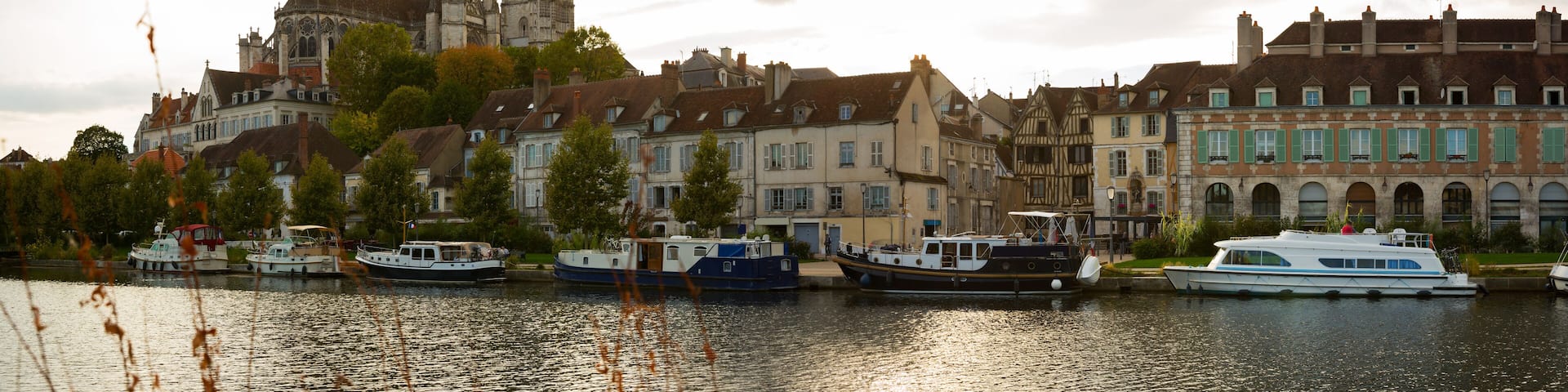 Image of view with river of famous old town Auxerre at cloudy day in France
