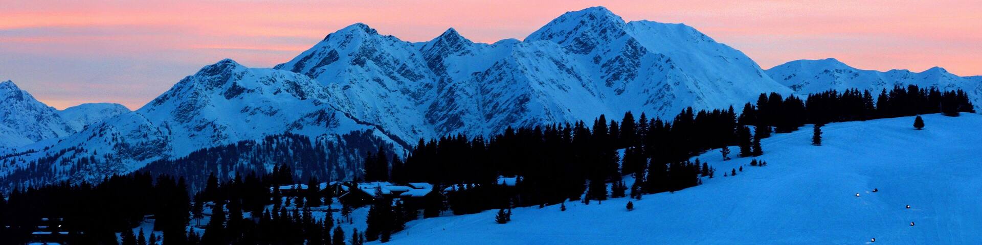Snow-covered mountains at sunset.