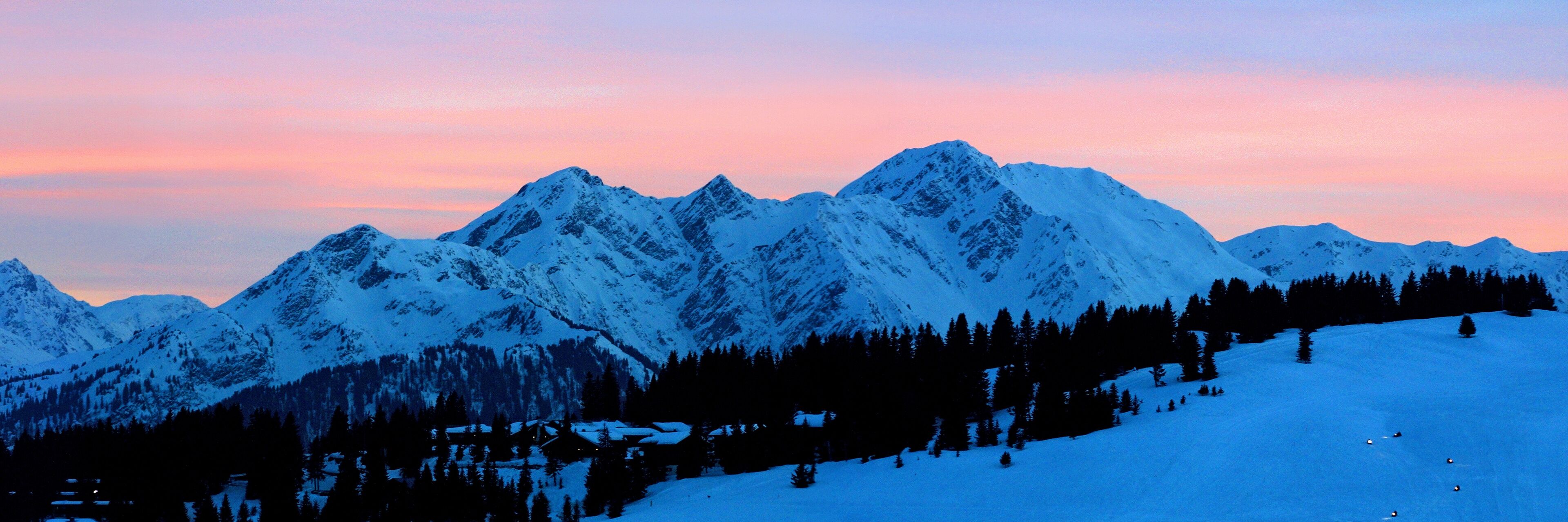 Snow-covered mountains at sunset.