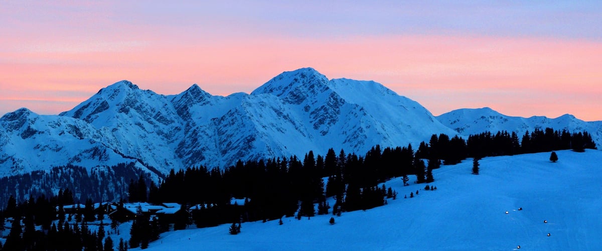 Snow-covered mountains at sunset.