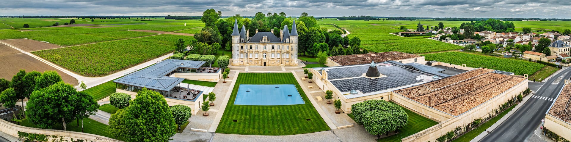 Panorama of Chateau Pichon Longueville Baron Vineyard and grape fields around Pauillac from a drone, Bordeaux, Gironde, Nouvelle-Aquitaine, France, Europe