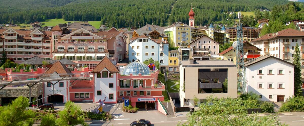 A town with colorful buildings, a prominent church with a red dome, and a parking area.