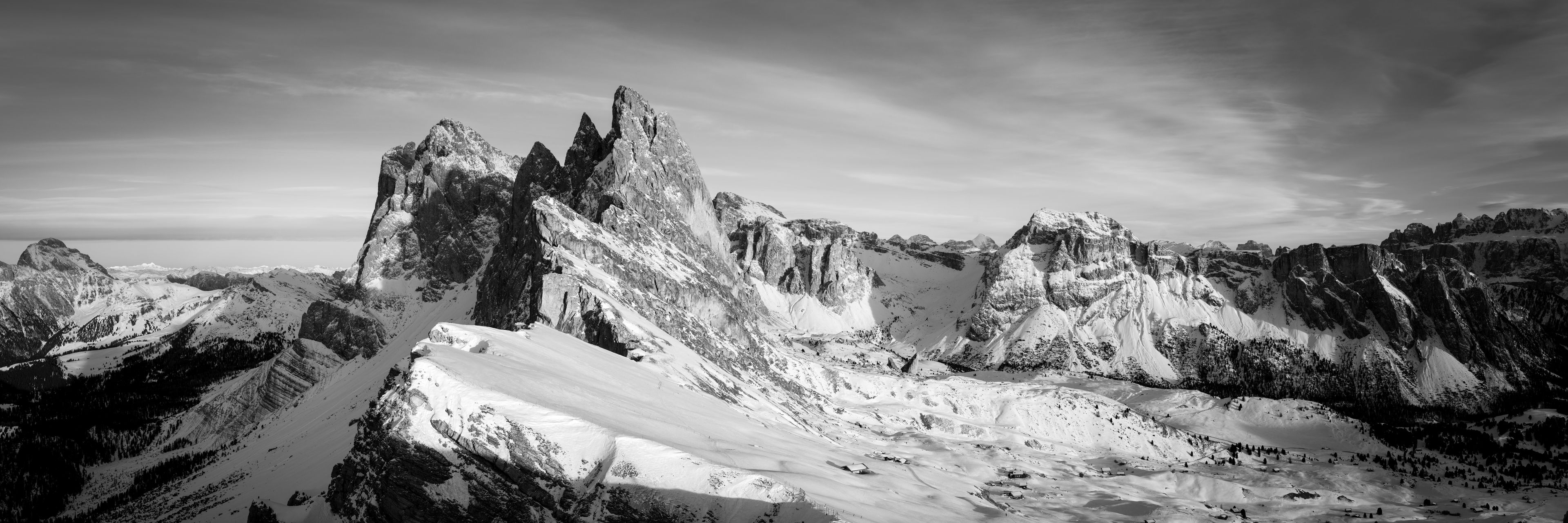 A mountainous landscape with snow-covered peaks and valleys.