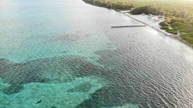 Eastern District East End beach in the Cayman Islands with board walj