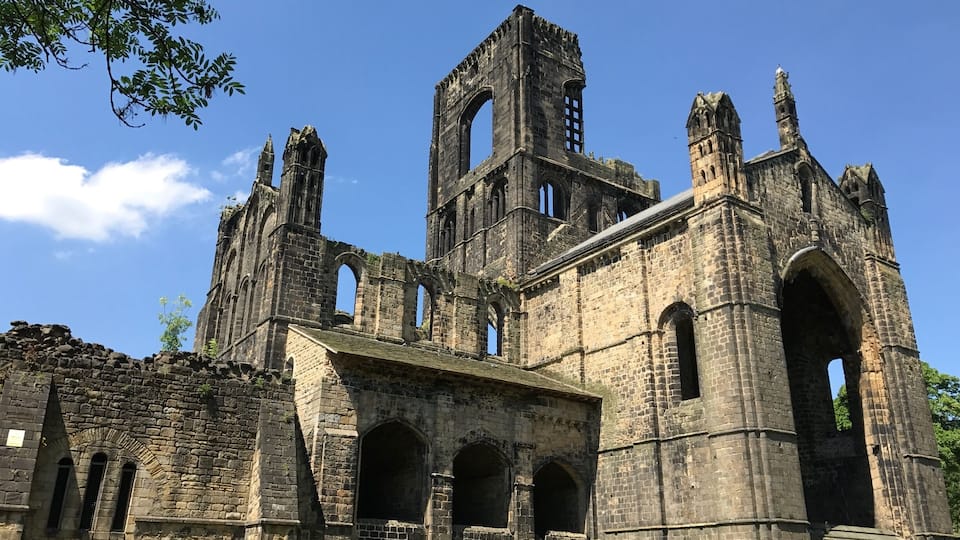 Kirkstall Abbey is a ruined Cistercian monastery in Kirkstall, north-west of Leeds city centre in West Yorkshire, England. It is set in a public park on the north bank of the River Aire.