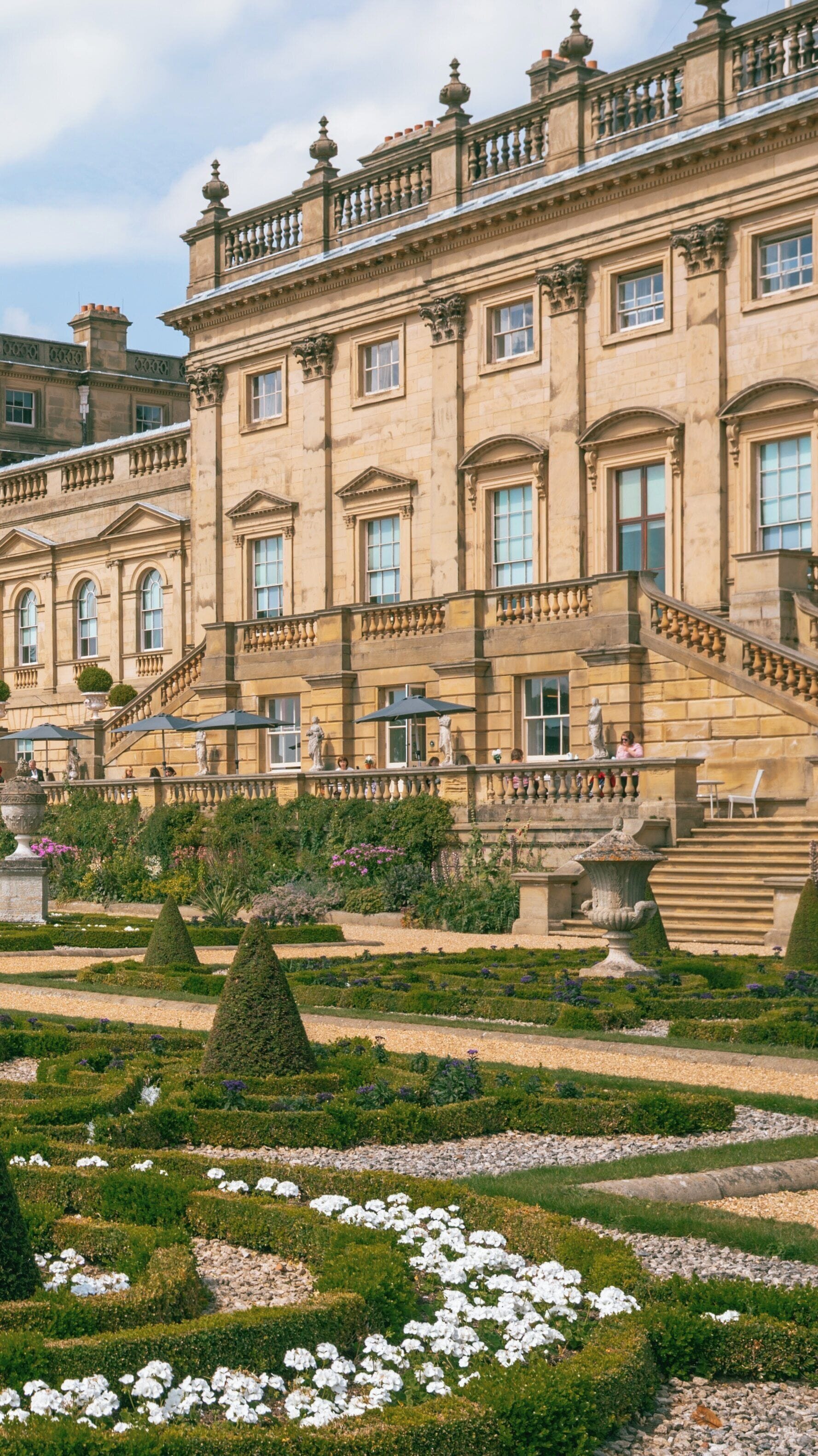 Harewood House showcases elegant architecture and well-maintained gardens in Leeds, England, during a sunny day, inviting visitors to explore its historic charm