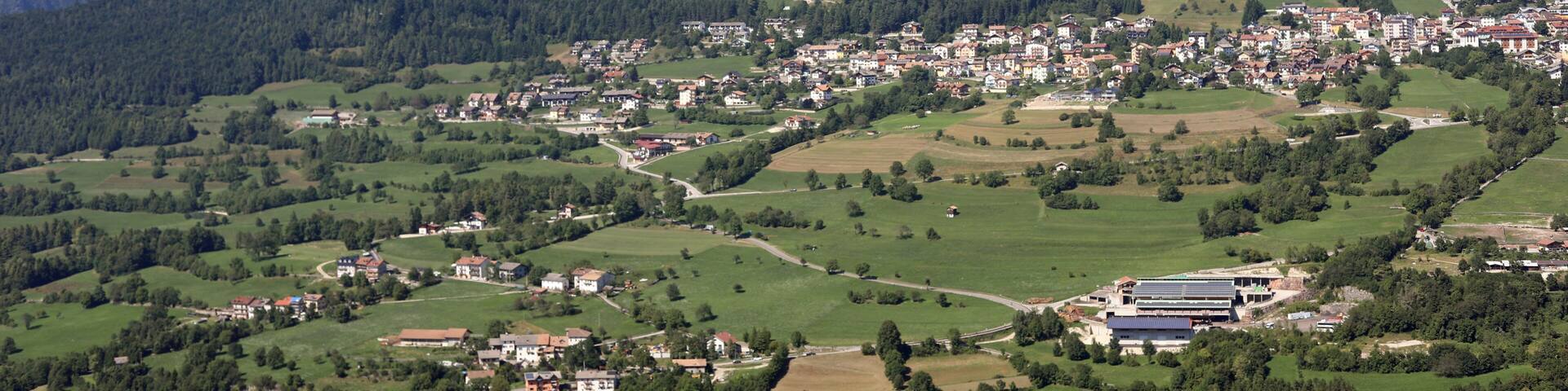 Panoramic view of the FOLGARIA Village in Northern Italy in Trentino Region and mountains called ALPE CIMBRA with trees