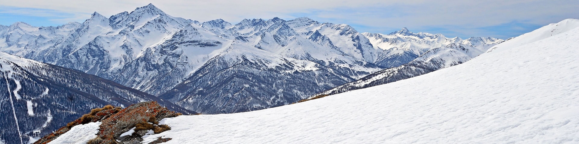 Majestic peaks in a winter scenery with Sestriere ski resort in the background,  Piedmont, italian Alps